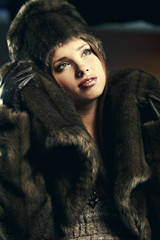 Fashion portrait of young pretty woman with fur