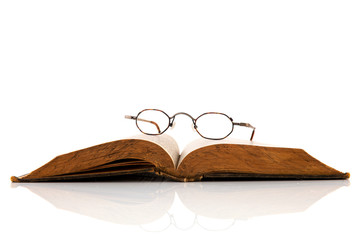 Old book with glasses