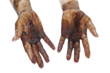 Human hands stained with black petroleum isolated on white