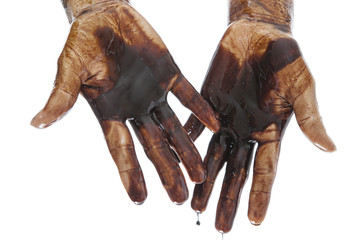 Stained human hands with black petrol. Isolated on white