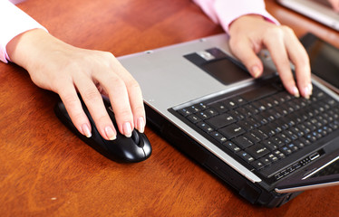 Hand with a computer mouse.