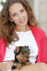 young attractive woman with yorkshire terrier puppy outdoors