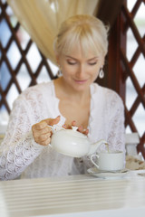 young beautiful smiling woman in street cafe - restaurant