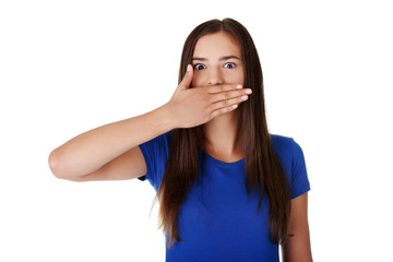 Teen woman covering mouth with hand