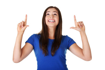 Happy , excited young woman pointing on copy space