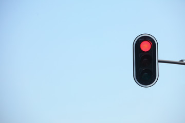 Red traffic lights against blue sky backgrounds