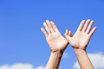 Bird made of hands over the blue sky