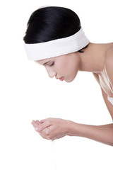 Obraz premium Beautiful woman is cleaning her face