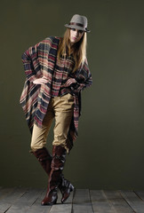 full body fashion woman in hat posing wooden floor