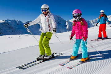 Skiing, winter, ski lesson - skiers on mountainside