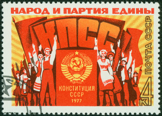 stamp printed shows a group of people at a rally meeting