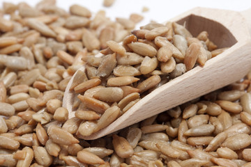 sunflower seeds from a wooden spoon