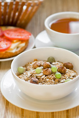 light breakfast with tea, fruit, sandwich and porridge