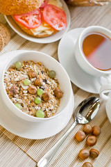 light breakfast with tea, fruit, sandwich and porridge