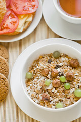 light breakfast with tea, fruit, sandwich and porridge