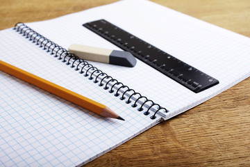 Close up of notebook with pencil and eraser