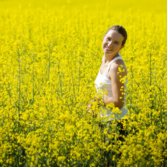 Woman in rapeseed field