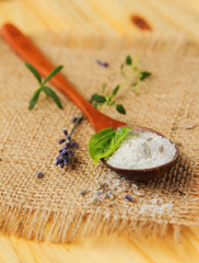 Healthy sea salt and herbs on wooden spoon