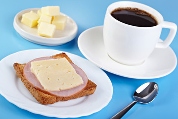 Breakfast. Cup of coffee and toast with ham and cheese