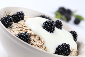 Oatmeal with yogurt and fresh organic blackberries