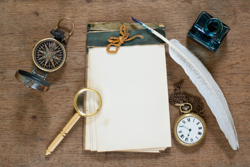 Old notebook, compass, watch, quill, inkwell, magnifying glass