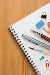 school supplies on  paper notepad