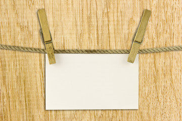 paper hang on clothesline with clipping path on wood background