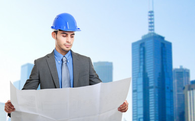 Portrait of a site manager reading a blueprint