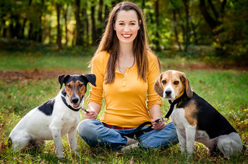 A beautiful woman and his dogs posing outside