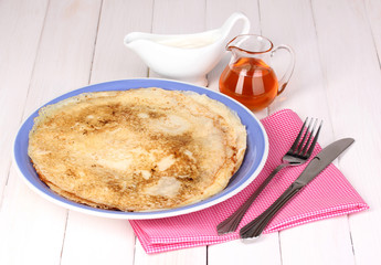 Stack of tasty pancakes on wooden background