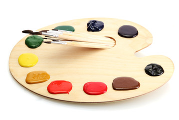 wooden art palette with  paint and brushes.isolated on white