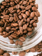 Heap of coffee beans from jar