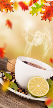 Autumn cup of tea with concept of falling leaves