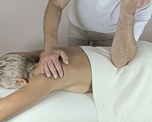 Male Therapist applying pressure with Elbow