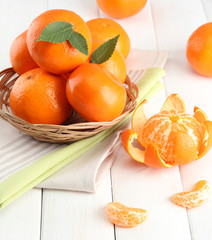 tangerines with leaves in a beautiful basket,