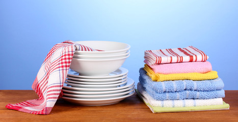 kitchen towels with dishes on blue background close-up