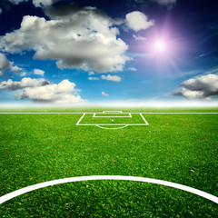 green field with blue sky