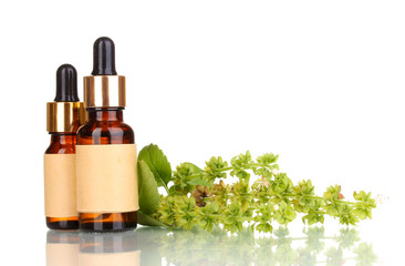 medicine bottles and flowers isolated on white