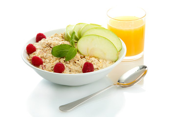 tasty oatmeal with raspberries and apple, isolated on white