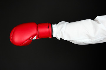 hand in boxing glove isolated on black