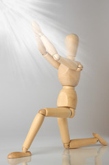 wooden man praying