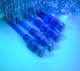 network cables and hub closeup with fiber optical background