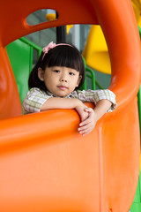 Fototapeta na wymiar Child plays slide at playground