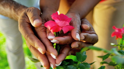 Hands Only Ethnic Couple Holding Flowers