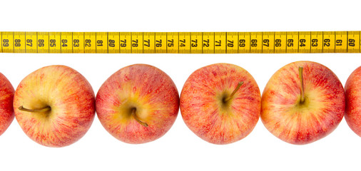 Red apples with a yellow tape-measure
