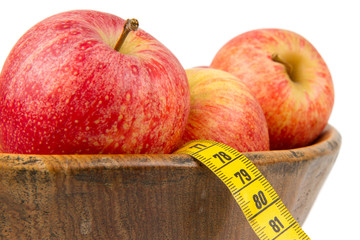 Red apples with a yellow tape-measure