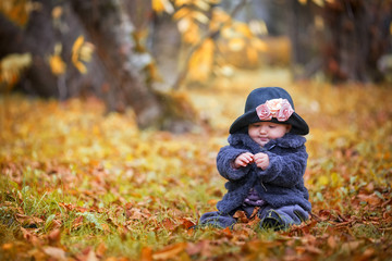 Baby girl playing with leaf