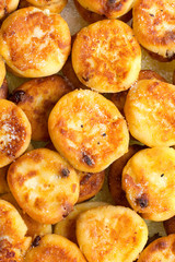 Homemade sweet cheese pancakes with raisins background