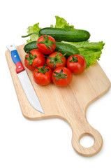 Tomatoes and cucumbers on white