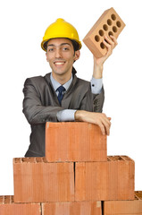 Businessman with bricks on white